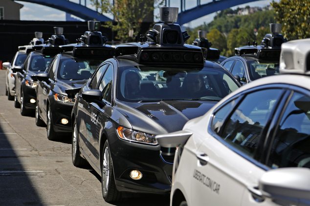 A group of self driving Uber vehicles position themselves to take journalists on rides during a media preview at Uber's Advanced Technologies Center in Pittsburgh, Monday, Sept. 12, 2016. Starting Wednesday morning, Sept. 14, 2016 dozens of self-driving Ford Fusions will pick up riders who opted into a test program with Uber. While the vehicles are loaded with features that allow them to navigate on their own, an Uber engineer will sit in the driver’s seat and seize control if things go awry. (AP Photo/Gene J. Puskar)